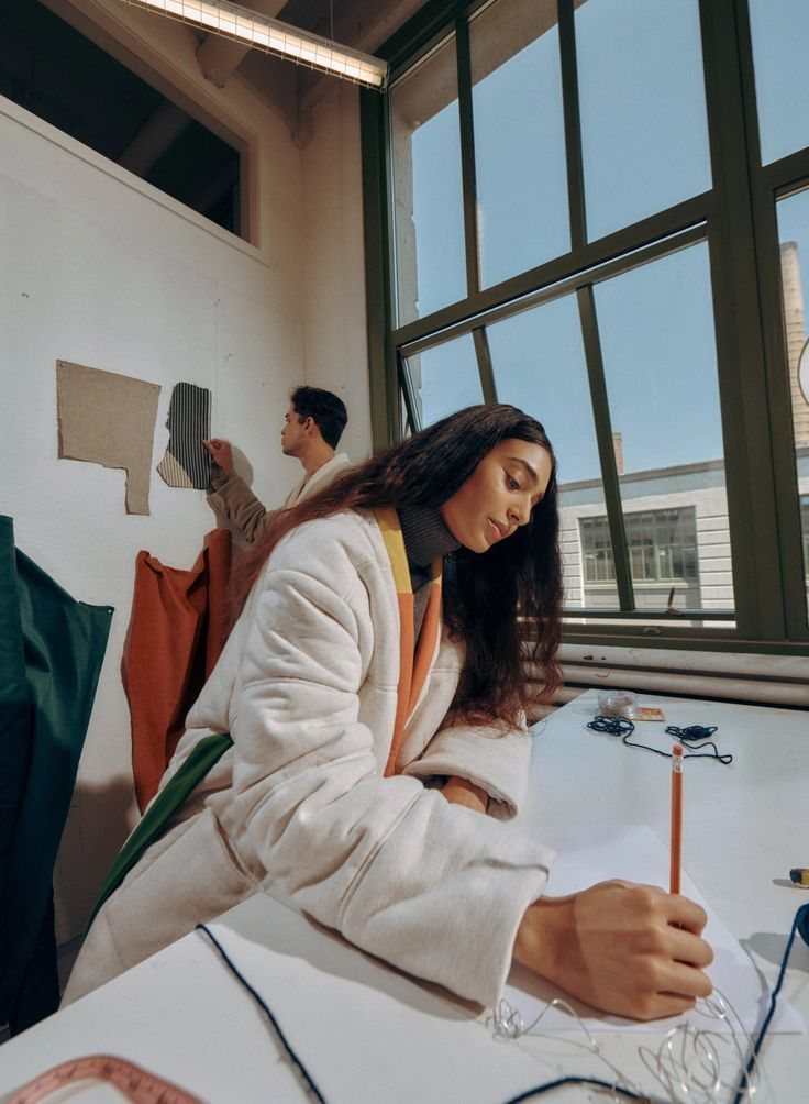 Siswa menggambar desain di studio kelas yang terang