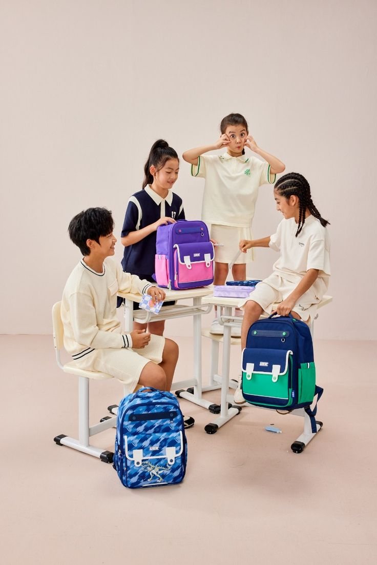 Anak-anak dengan tas sekolah di meja kelas